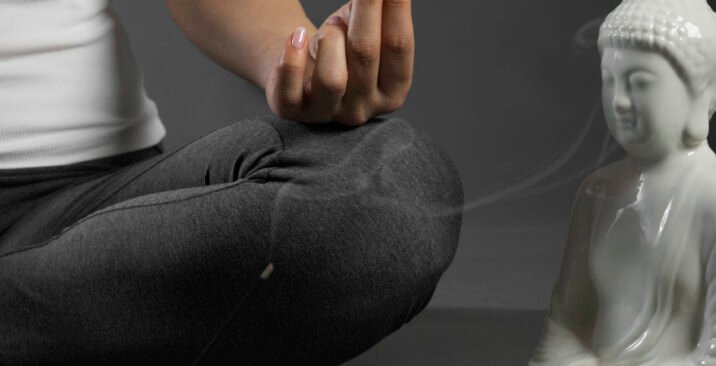 person-meditating-buddha-statuette